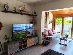 a living room with a flat screen tv at Miliő Apartman Sarud in Sarud