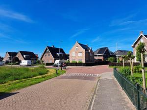 a street in a residential neighborhood with houses at Villa shared Fieldsight Doornspijk - a shared villa no breakfast in Doornspijk