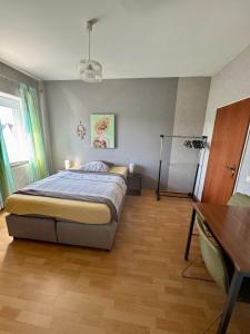 a bedroom with a bed and a table in it at Gemütliche Apartments in Bendorf