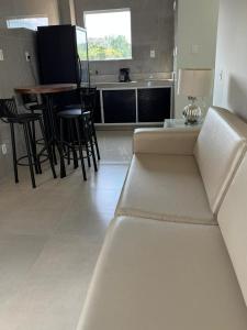 a living room with a couch and a table and chairs at University Suítes in Carmópolis +8 photos