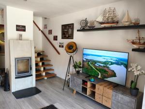 a living room with a large flat screen tv at Miliő Apartman Sarud in Sarud