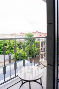 a table on a balcony with a view of the city at Grand Afrosiyob Hotel in Tashkent