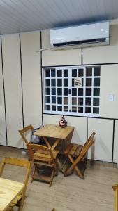 a table and chairs in a room with a window at House of Colors Hotel in Manaus