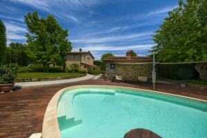 a swimming pool in front of a house at Mhateria Relais - Relax in Villa con Piscina in Toscana in Rignano sullʼArno