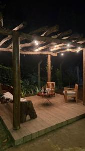 a wooden deck with a pergola at night at Pousada raios de sol in Chapada dos Guimarães