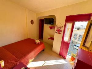 a small bedroom with a bed and a window at Posada "Jardin Huasteca Xilitla" in Xilitla