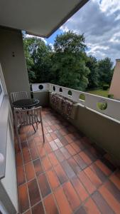 a patio with a table and a bench on a balcony at 2 Zimmer Ferienwohnung nahe Schweiz in Bad Säckingen