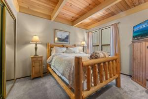a bedroom with a wooden bed and a window at Bed-N-Bliss in Kings Beach