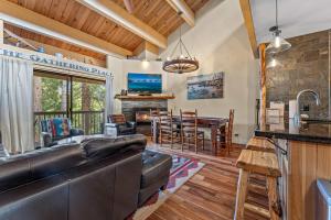 a living room with a leather couch and a dining room at Bed-N-Bliss in Kings Beach