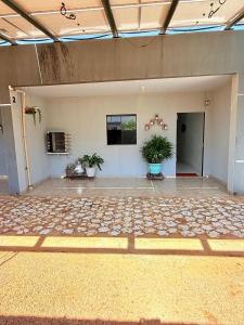 a large empty room with potted plants in it at Apartamento do Graf 2 in Sorriso