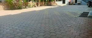 a cobblestone street with a wrapper on the ground at New Hotel Shree Ganga in Shājāpur