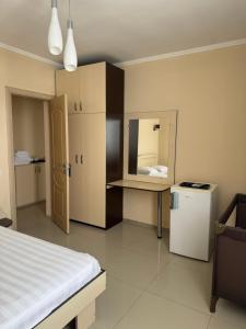 a bedroom with a bed and a small refrigerator at Asteria in Odesa