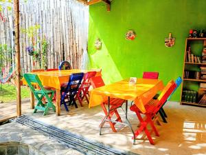 a dining room with colorful tables and chairs at Posada "Jardin Huasteca Xilitla" in Xilitla
