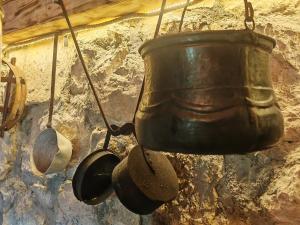 a pot and pans hanging on a wall at Etno House Šćepanov Hlad in Virpazar