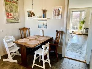a dining room with a wooden table and chairs at Rørvig Bed & Kitchen in Rørvig
