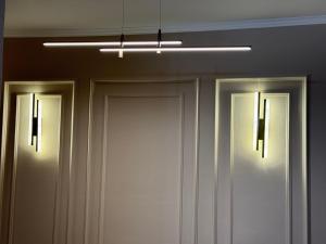 two doors in a room with a light above them at Za Apartment 2 in Korçë