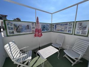 two chairs and a table and an umbrella on a boat at Blumoon Capri con accesso Piscina in Anacapri