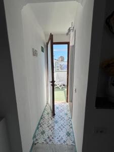 a stairway with a door leading to a patio at Blumoon Capri con accesso Piscina in Anacapri