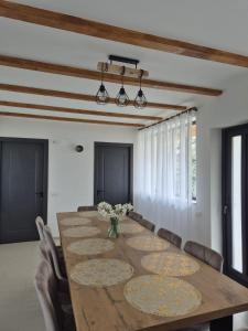 a dining room with a large wooden table and chairs at Casa LSA in Arefu