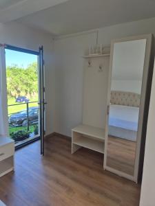 a bedroom with a bunk bed and a mirror at Casa LSA in Arefu