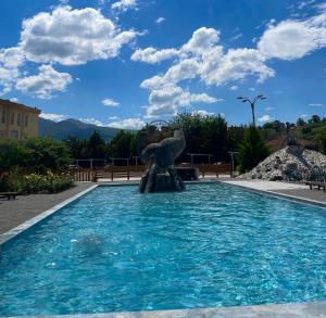 a fountain in the middle of a swimming pool at Kriva Resort in Elbasan