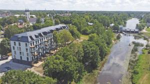 an aerial view of a building next to a river at Apartment in the city center near park and river 26 in Marijampolė