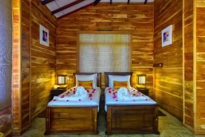 A bed or beds in a room at Karunakarala Ayurveda Resort