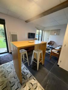 a room with a wooden desk and two stools at Sab in Beaudreix