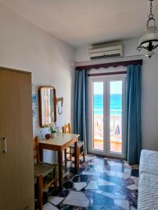 a room with a table and a view of the ocean at Lefteris Rooms in Kokkari
