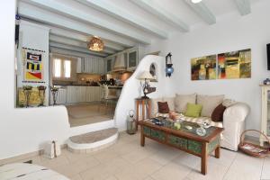 a living room with a couch and a table at Yria Holiday Home Paros in Márpissa