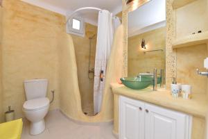 a bathroom with a toilet and a sink and a shower at Yria Holiday Home Paros in Márpissa +32 photos