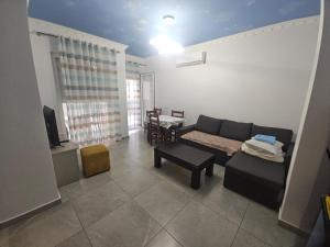 a living room with a couch and a table at Sea&Stay in Shëngjin