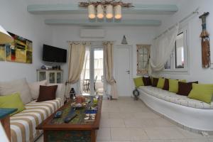a living room with a couch and a table at Yria Holiday Home Paros in Márpissa