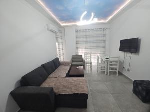 a living room with a couch and a table at Sea&Stay in Shëngjin