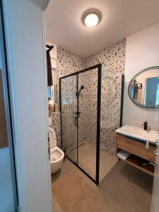 a bathroom with a shower and a toilet and a sink at Villa Una Bellevue in Bihać +30 photos