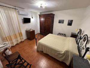 a bedroom with a bed and a table and chairs at B&B Casa Doria in Castelsardo