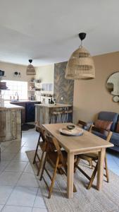 a dining table and chairs in a living room at Casa del Castel in Dreux