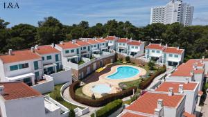 an aerial view of a group of houses and a swimming pool at L&A Villa Prainha 3 Bedrooms Heated Pool 5 m walking to the beach in Alvor