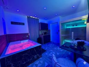 a room with a tub with a red liquid in it at Hermitage Spa in Dijon