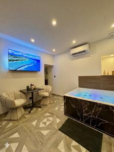 a living room with a large tub in a room at Hermitage Spa in Dijon