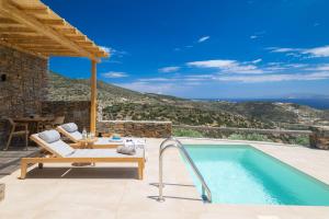a villa with a swimming pool with a view at Refoulia Eco Suites in Vathi