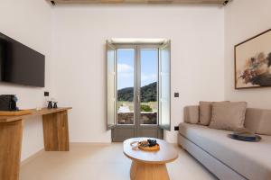 a living room with a couch and a table at Refoulia Eco Suites in Vathi