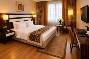 a hotel room with a large bed and a desk at Akgun Hotel Beyazit in Istanbul