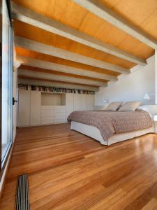 a bedroom with a bed and a wooden ceiling at La Força Penthouse in Girona