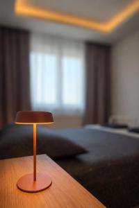 a small wooden stool sitting on a table in a bedroom at LuckyCat Apartment in Osijek