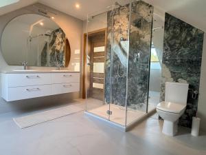 a bathroom with a glass shower and a toilet at Willa Sielanka in Becejły +58 photos