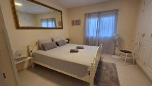 a bedroom with a large bed and a mirror at Callao Sun & Pool by Diamanteholidays in Callao Salvaje
