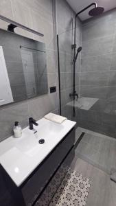 a bathroom with a white sink and a shower at Callao Sun & Pool by Diamanteholidays in Callao Salvaje +13 photos
