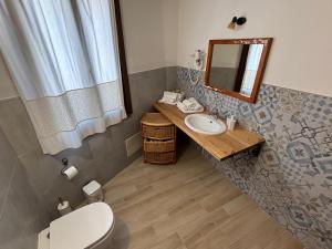 a bathroom with a toilet and a sink and a mirror at B&B Casa Doria in Castelsardo +83 photos