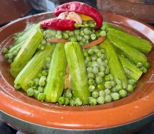 a plate of green vegetables on a table at Gîte Chez habitant in Telouet